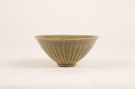 A CHINESE YAOZHOU TEA BOWL. Song Dynasty. The interior moulded with six peony blossoms borne on an