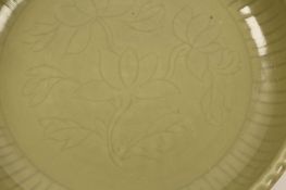 A CHINESE LONGQUAN CELADON “LOTUS’ DISH. Ming Dynasty. Of shallow form rising from a short foot to a