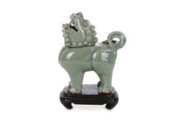 A CHINESE CELADON-GLAZED 'LION' INCENSE BURNER AND COVER. Qing Dynasty. Standing four-square, with a