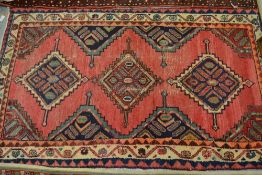 Hamadan rug, triple medallion design on a rose ground with multiple borders and another machine made