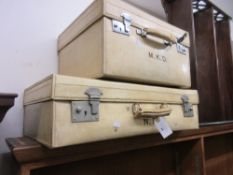 Two early 20th Century white leather suitcases bearing owners initials