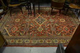 Mahal carpet with a medallion and all-over stylised floral design on a red ground with borders (