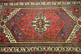 Small Hamadan rug with single gol on a wine red and blue ground with multiple borders, 4ft x 3ft